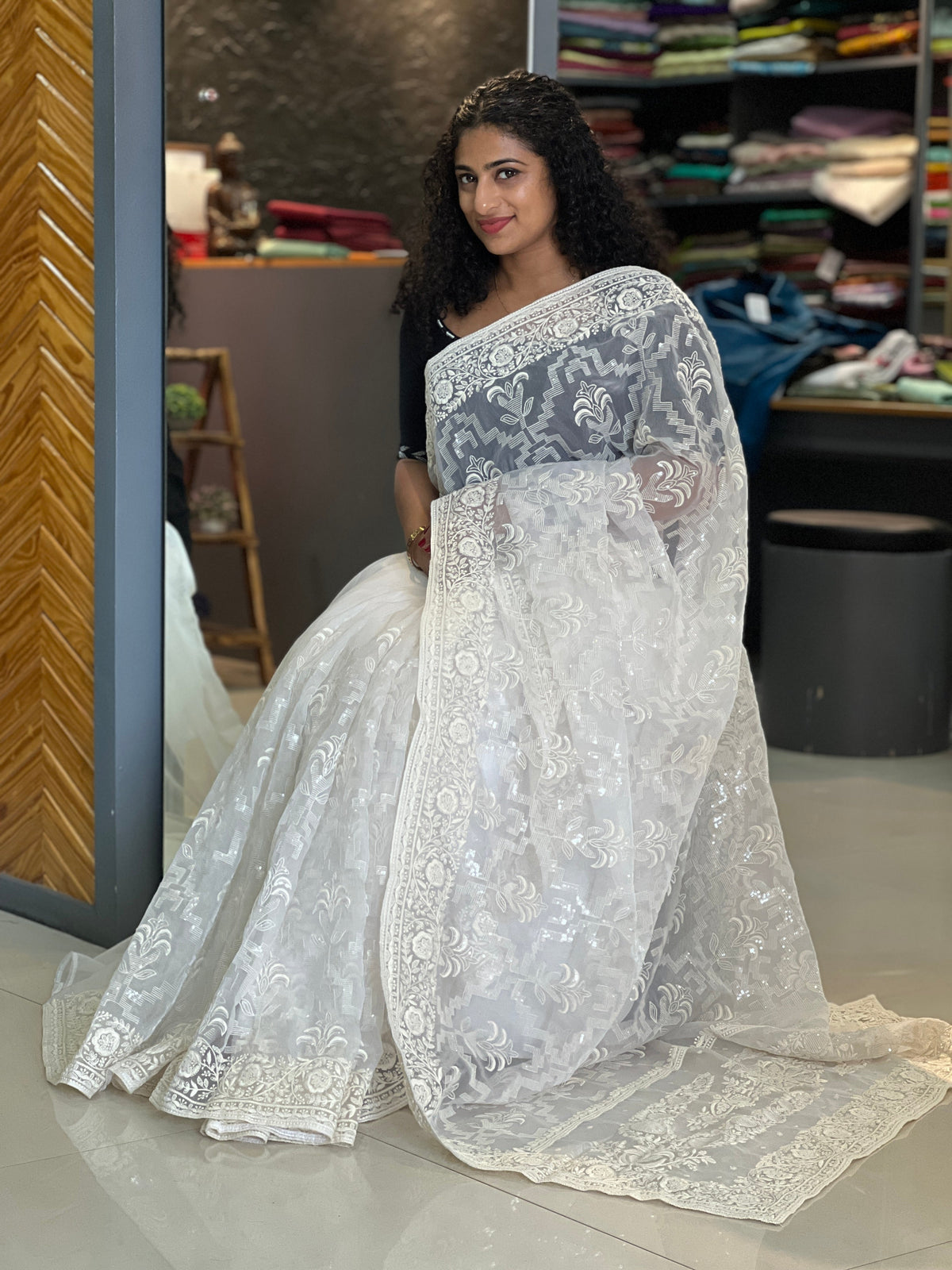 A white organza saree with delicate work, elegant for Christmas and New Year
