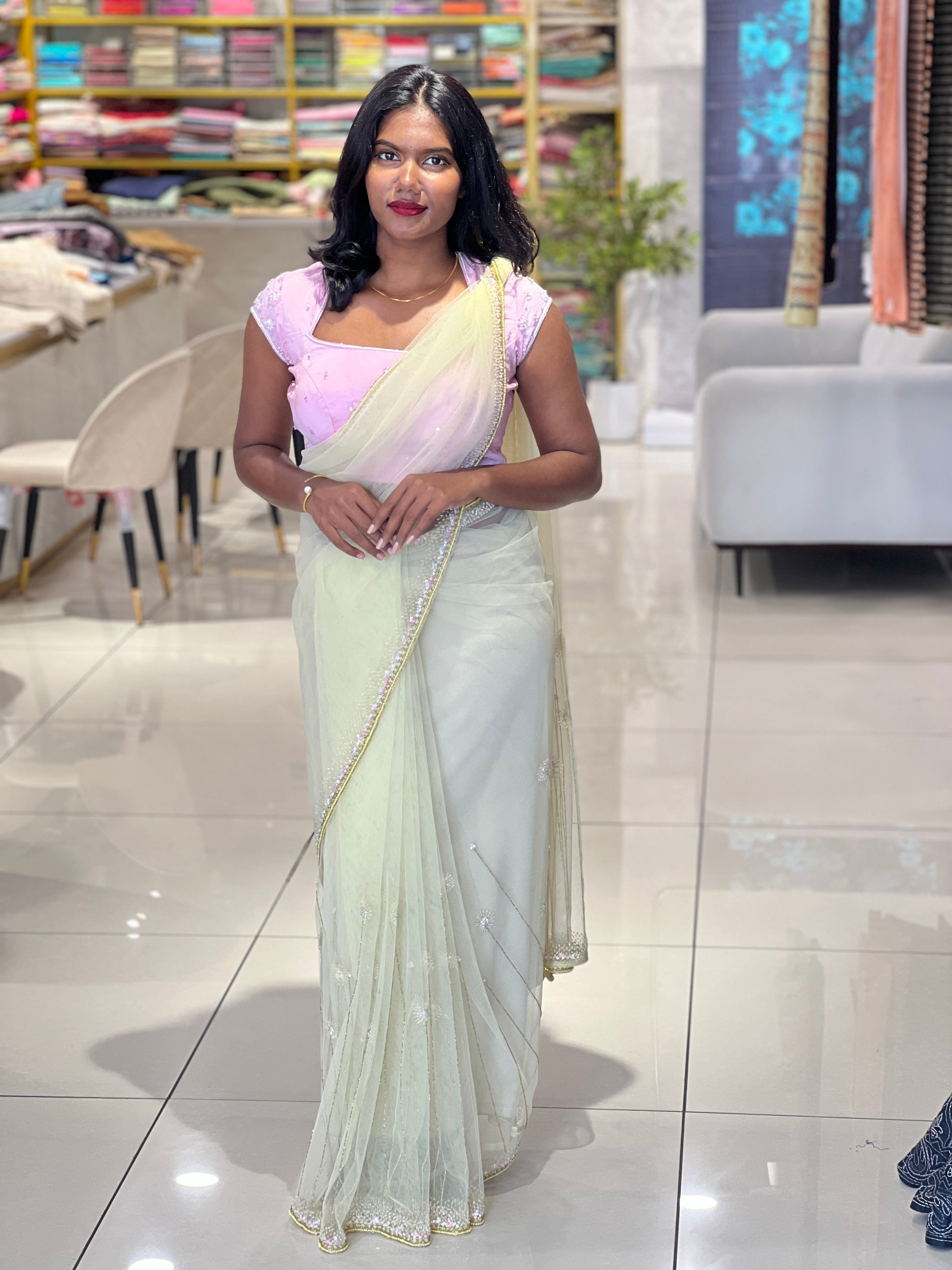 Beads work embroidered net saree with dense embellishment on a sheer mesh ground