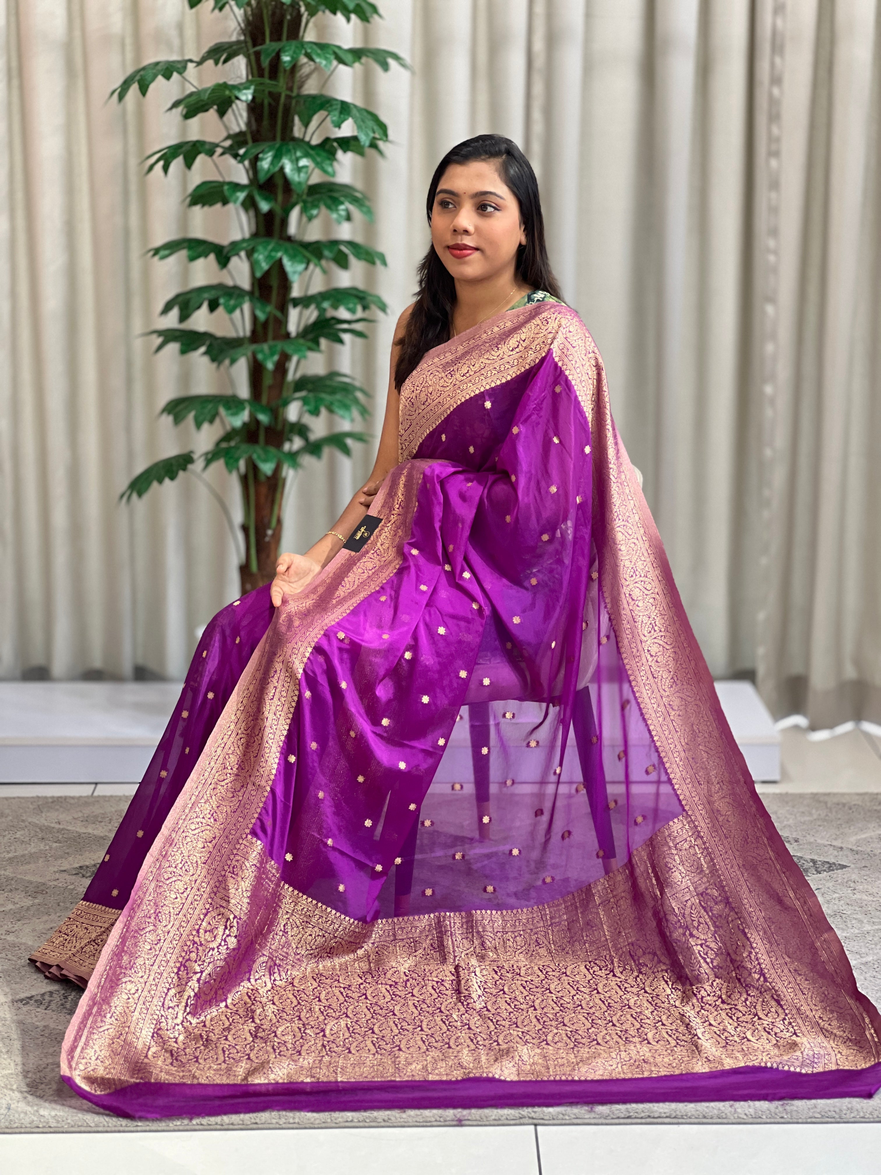 A woven-buta crepe saree in a deep tone, polished and appropriate for the office